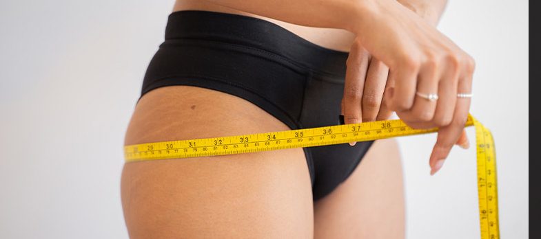 image of woman measuring weight loss